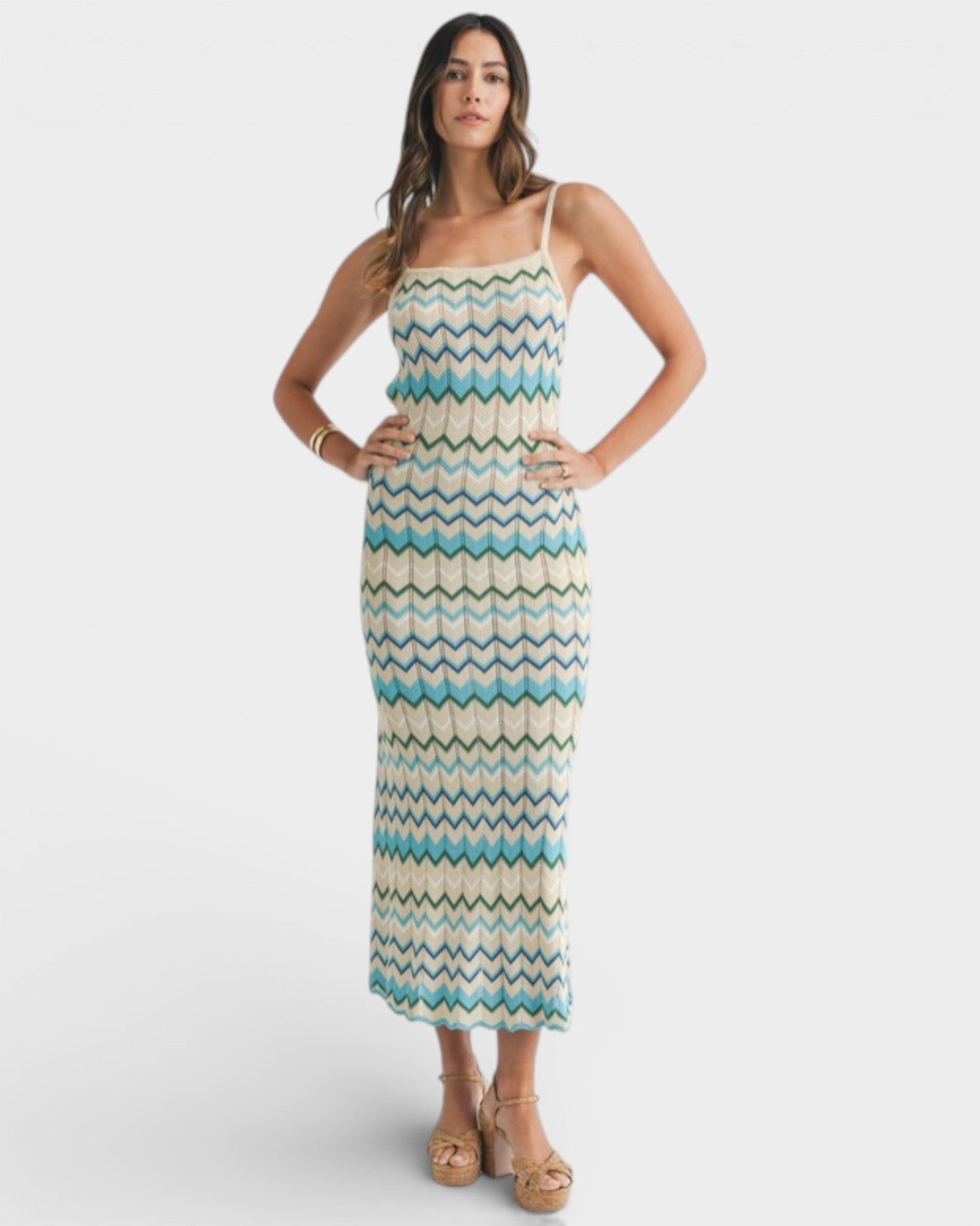 Woman wearing a patterned dress on a white background