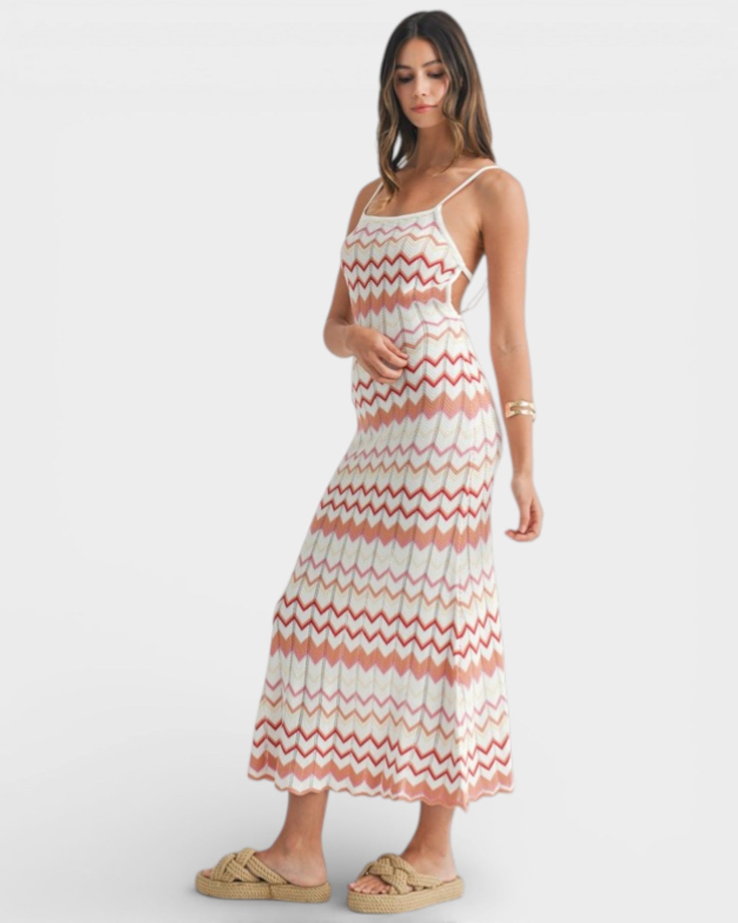 Woman wearing a zigzag patterned dress on a white background