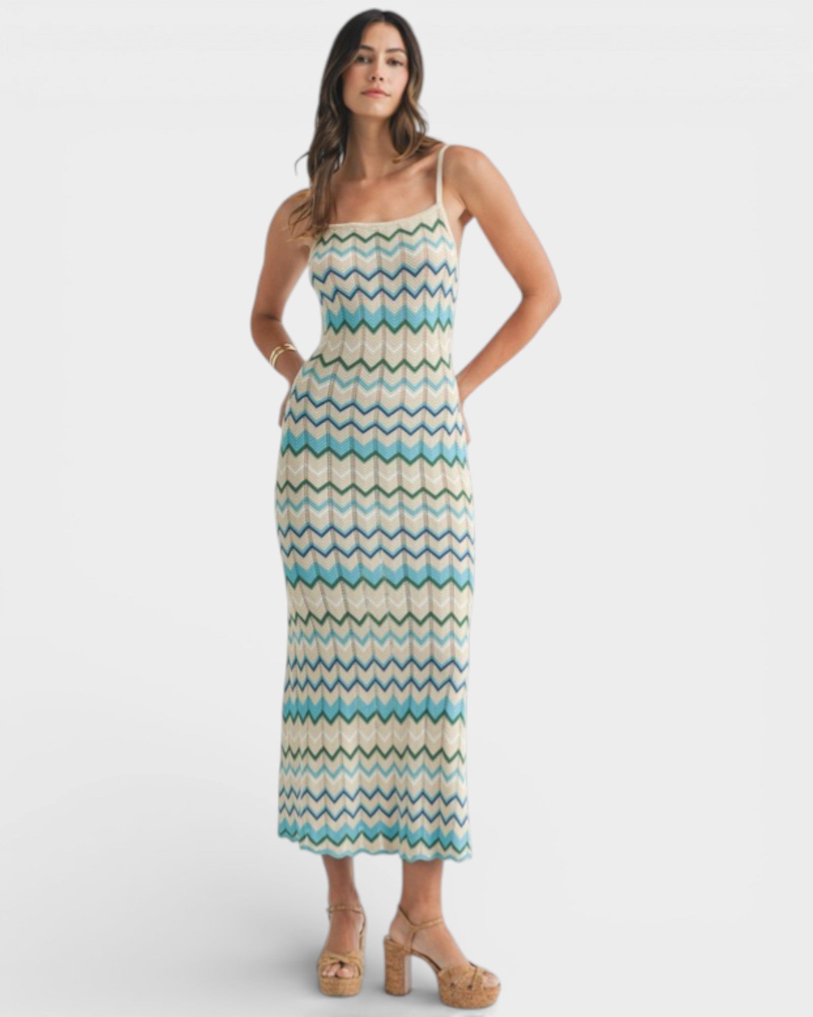 Woman wearing a patterned dress on a white background