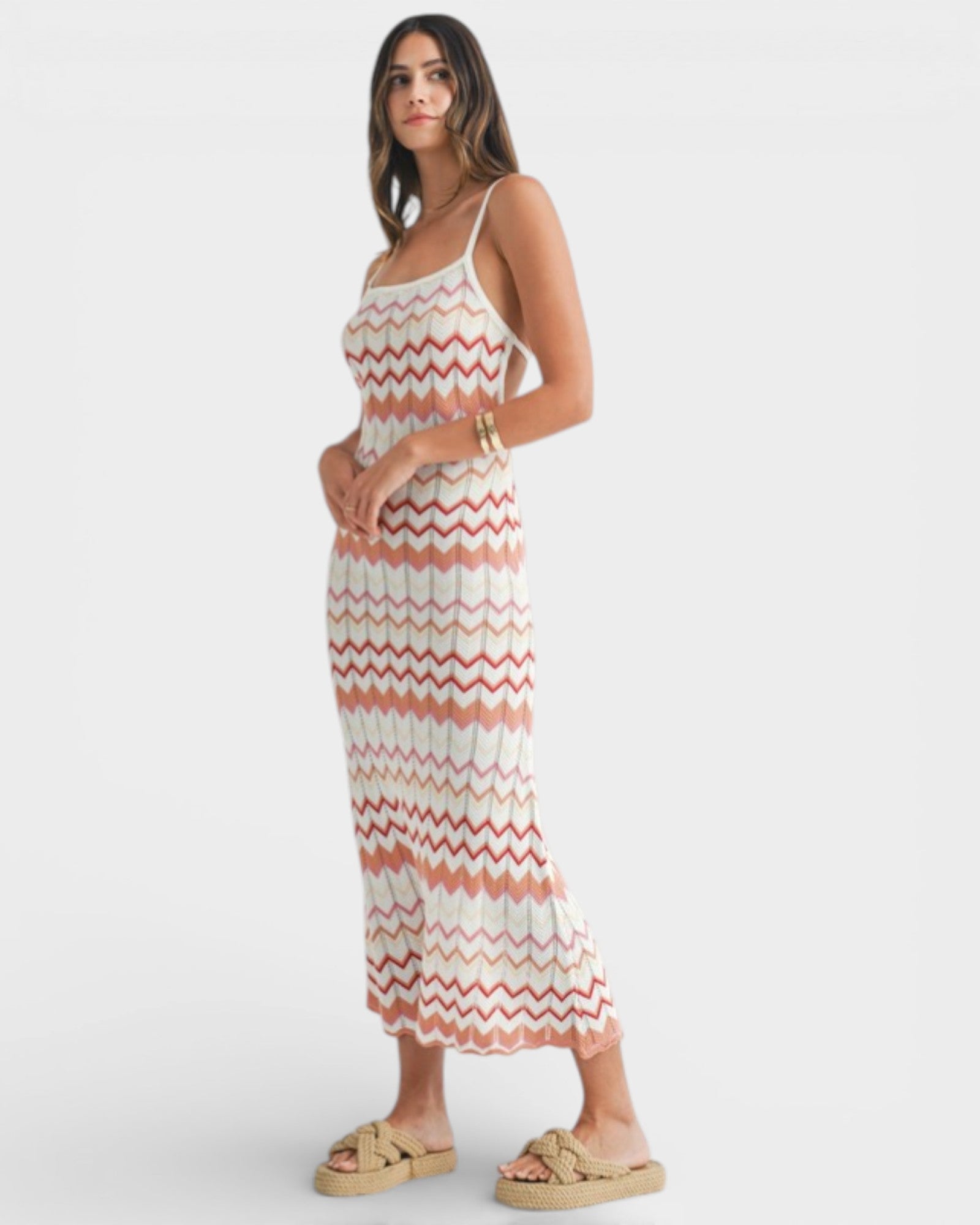 Woman wearing a zigzag patterned dress on a white background