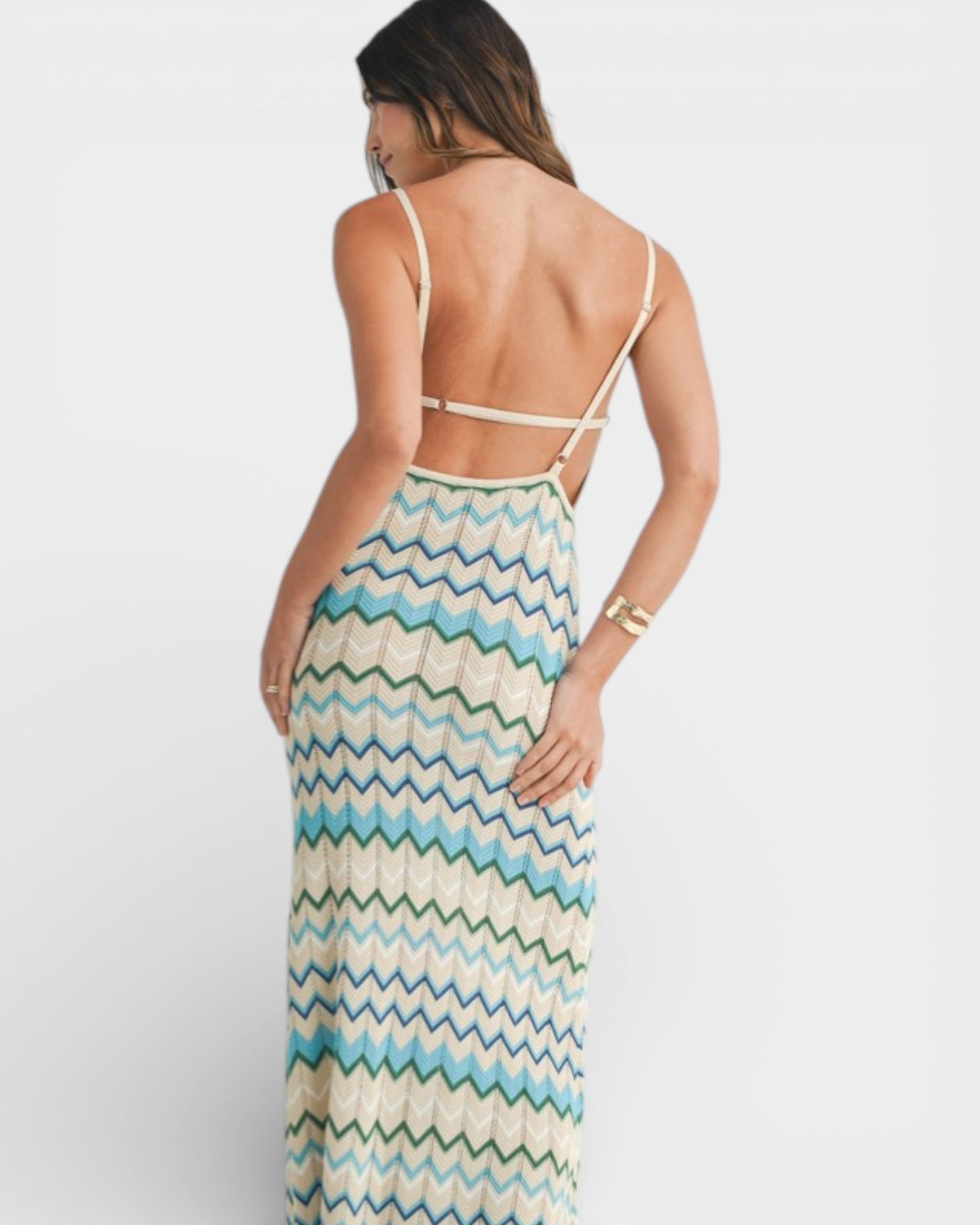 Woman wearing a zigzag patterned dress on a white background