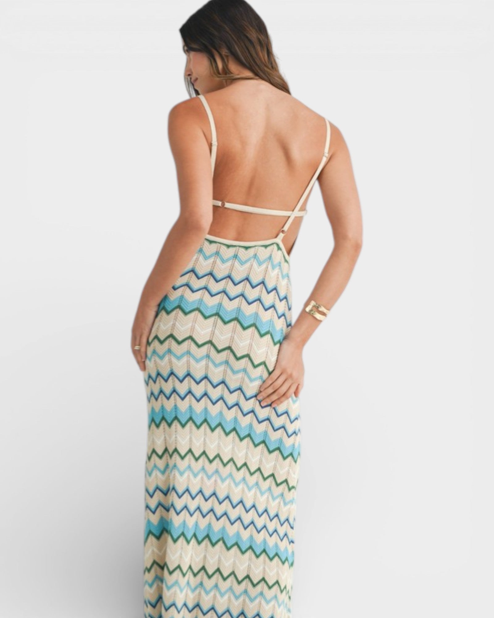 Woman wearing a zigzag patterned dress on a white background