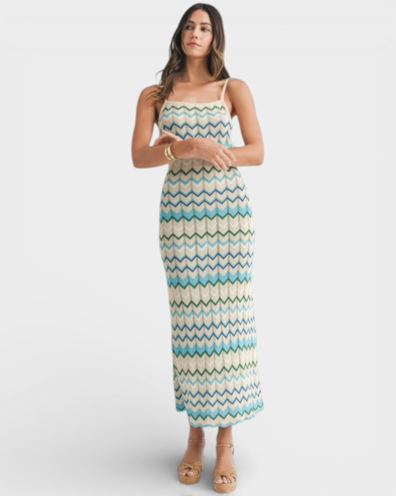 Woman wearing a patterned dress on a white background