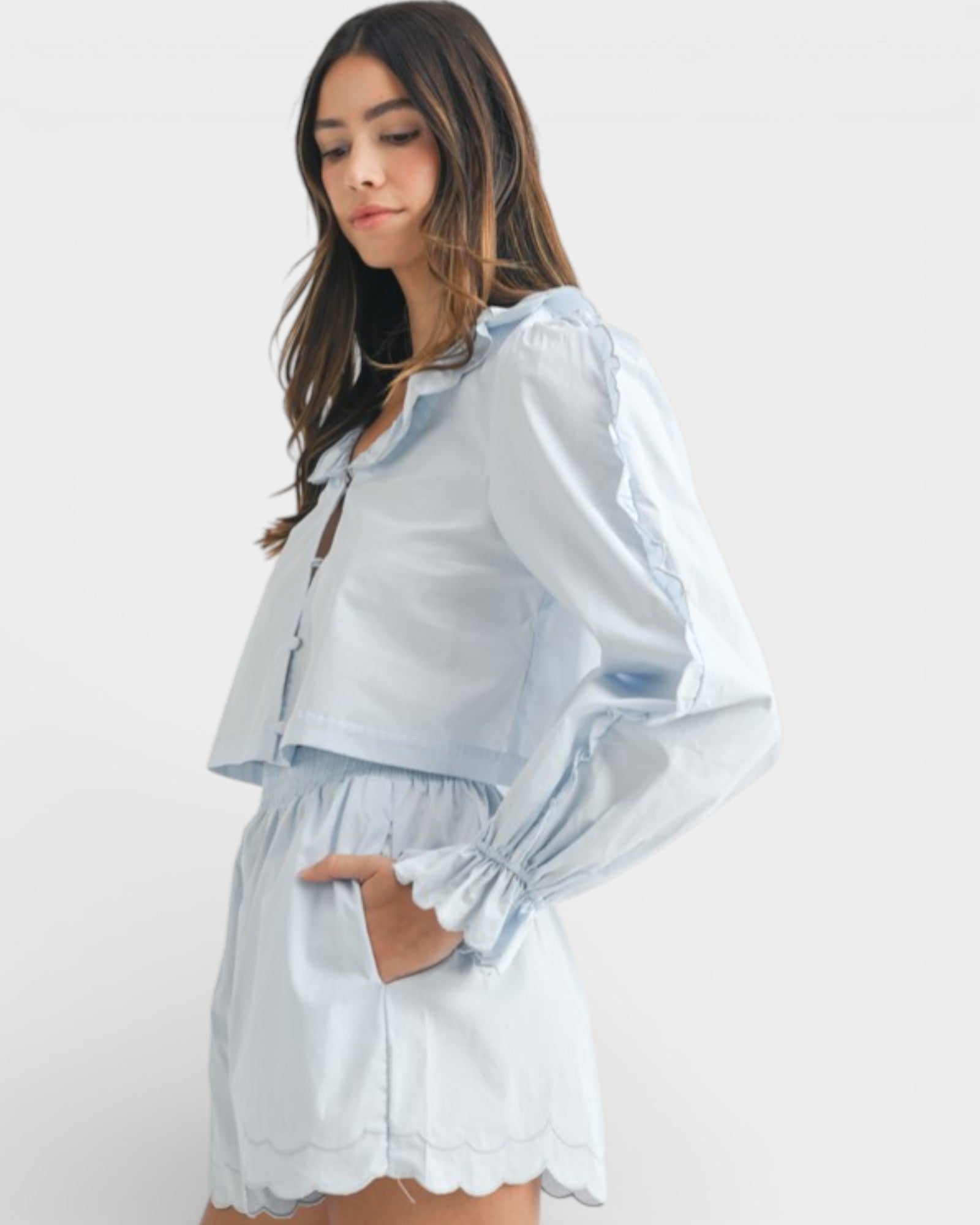 Woman wearing a light blue outfit with a white background
