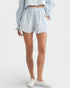 Person wearing light blue shorts and a matching top on a white background