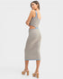 Woman wearing a patterned dress on a white background