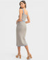 Woman wearing a patterned dress on a white background