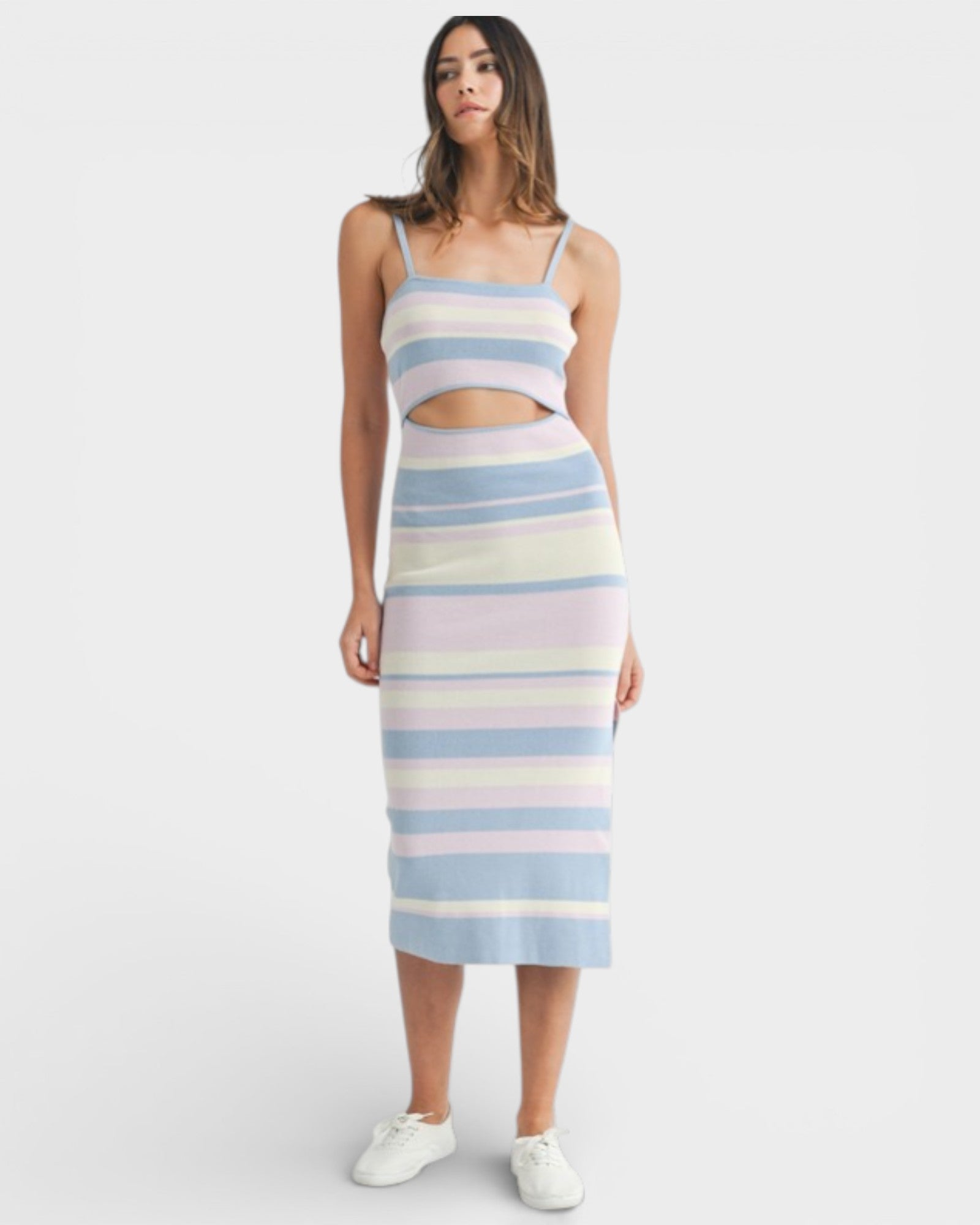 Woman wearing a pastel striped dress on a white background