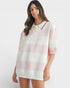 Woman wearing a white and pink striped dress against a white background