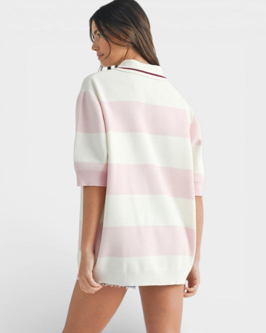 Woman wearing a pink and white striped shirt on a plain background