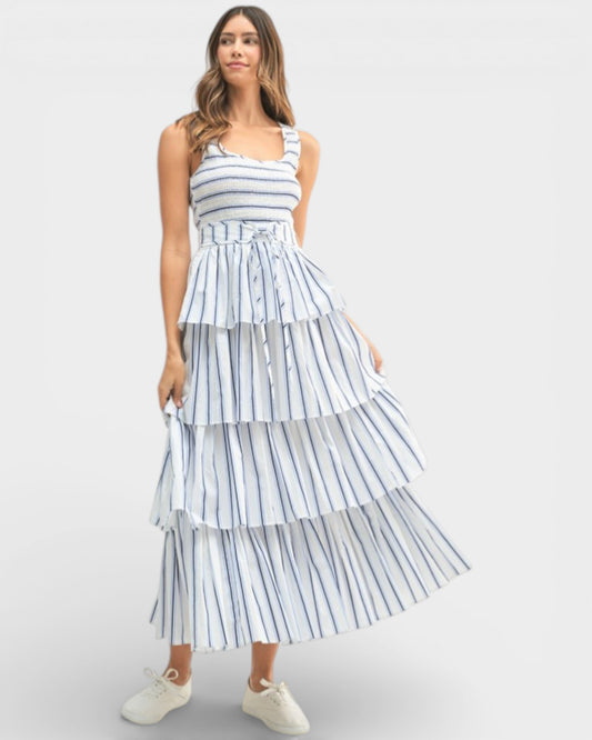 Woman wearing a tiered striped dress on a white background