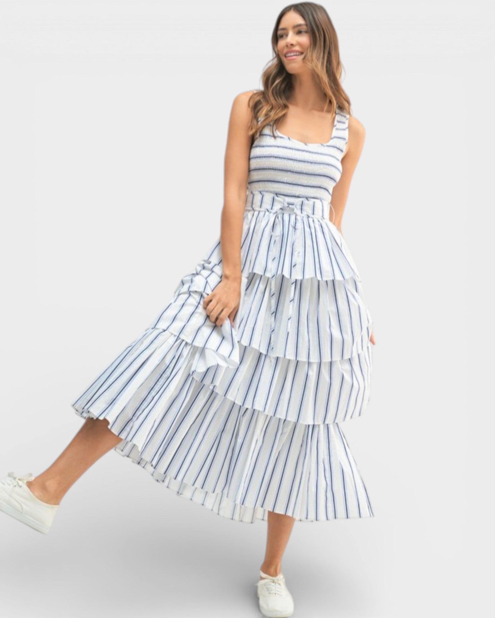 Woman wearing a blue and white striped dress on a white background