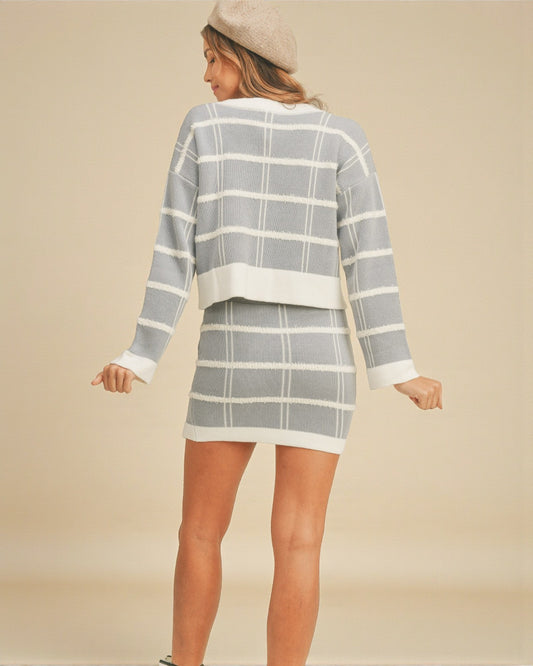 Woman wearing a gray and white checkered outfit on a beige background