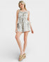 Woman wearing a plaid romper on a white background