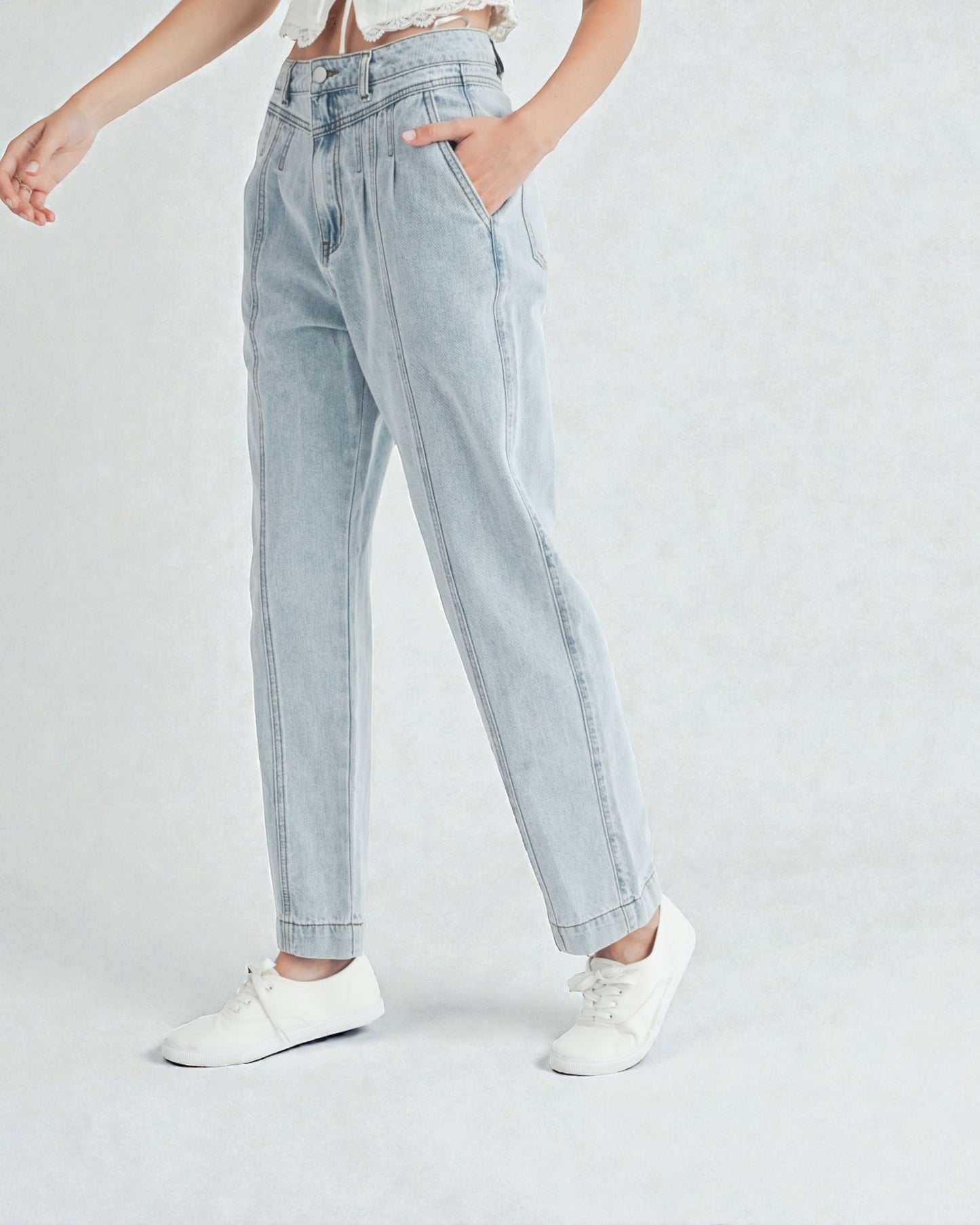 Light blue jeans worn by a person on a white background