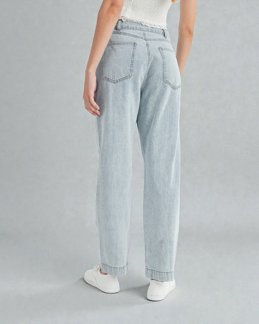 Light blue jeans worn by a person on a gray background