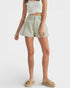 Person wearing a light green pleated skirt on a white background