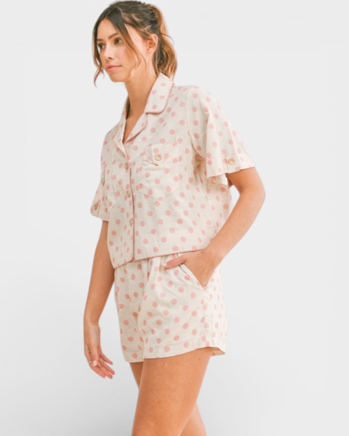 Woman wearing a floral pajama set on a white background