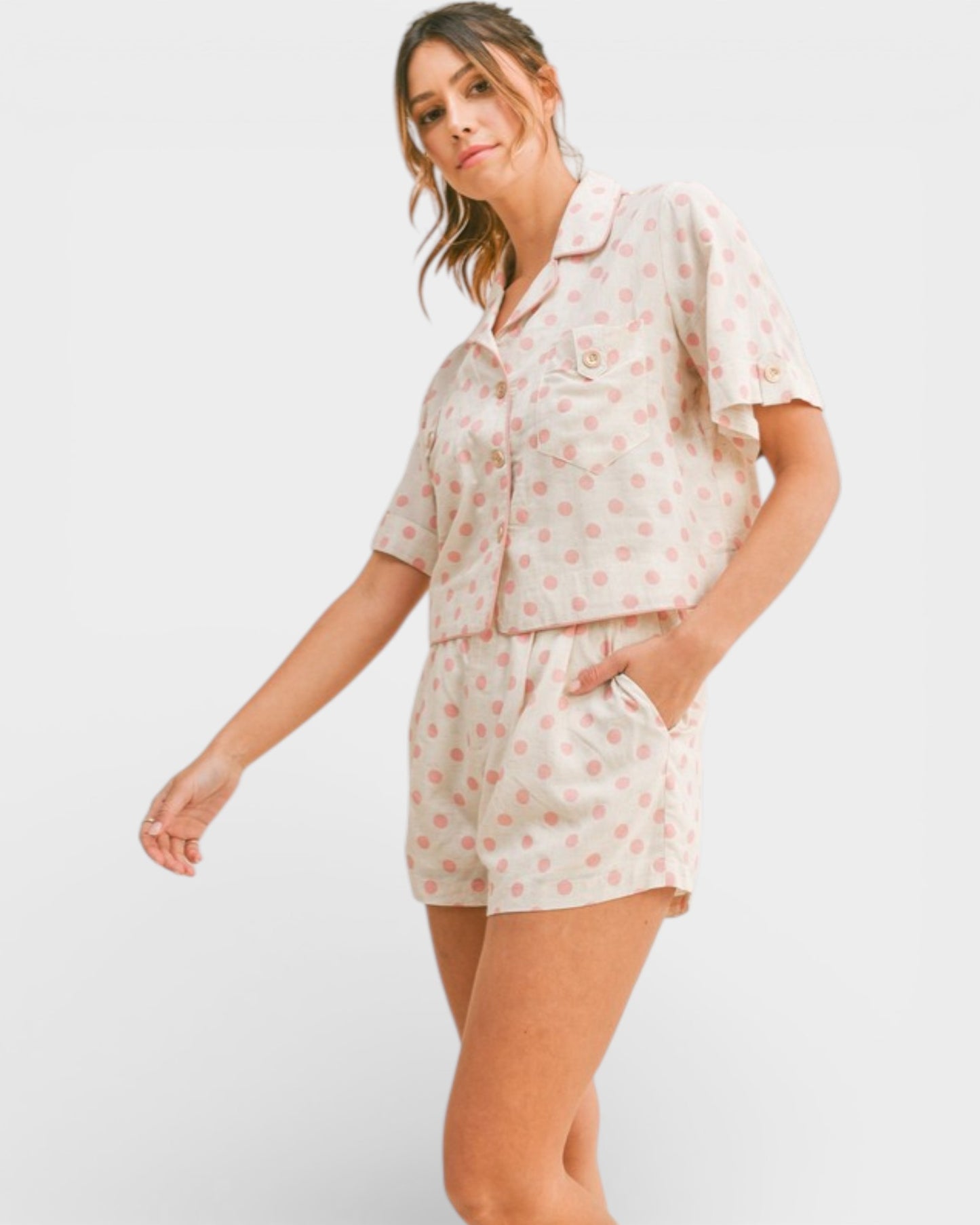 Woman wearing a floral pajama set on a white background