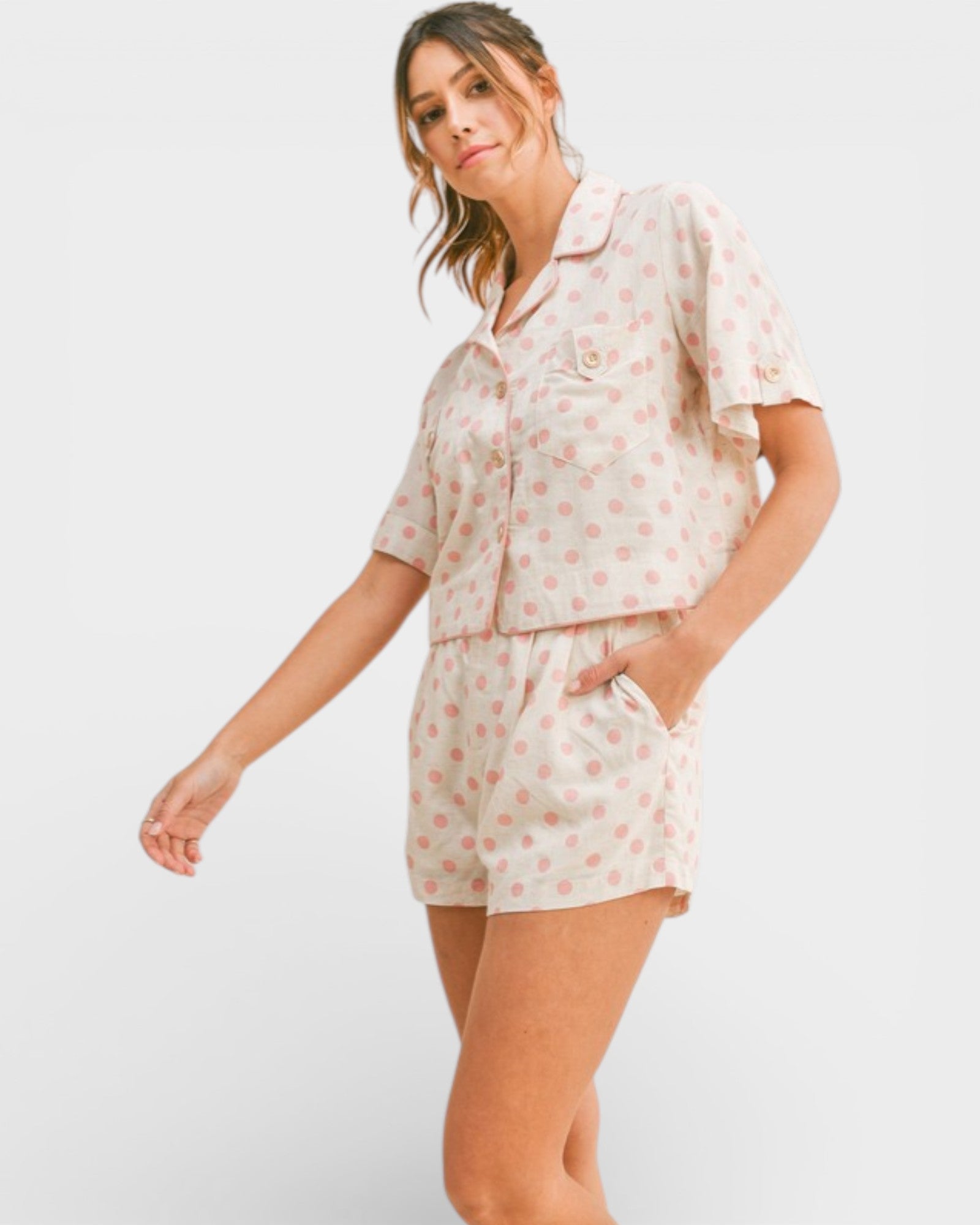 Woman wearing a floral pajama set on a white background