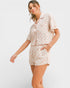 Woman wearing a floral pajama set on a white background