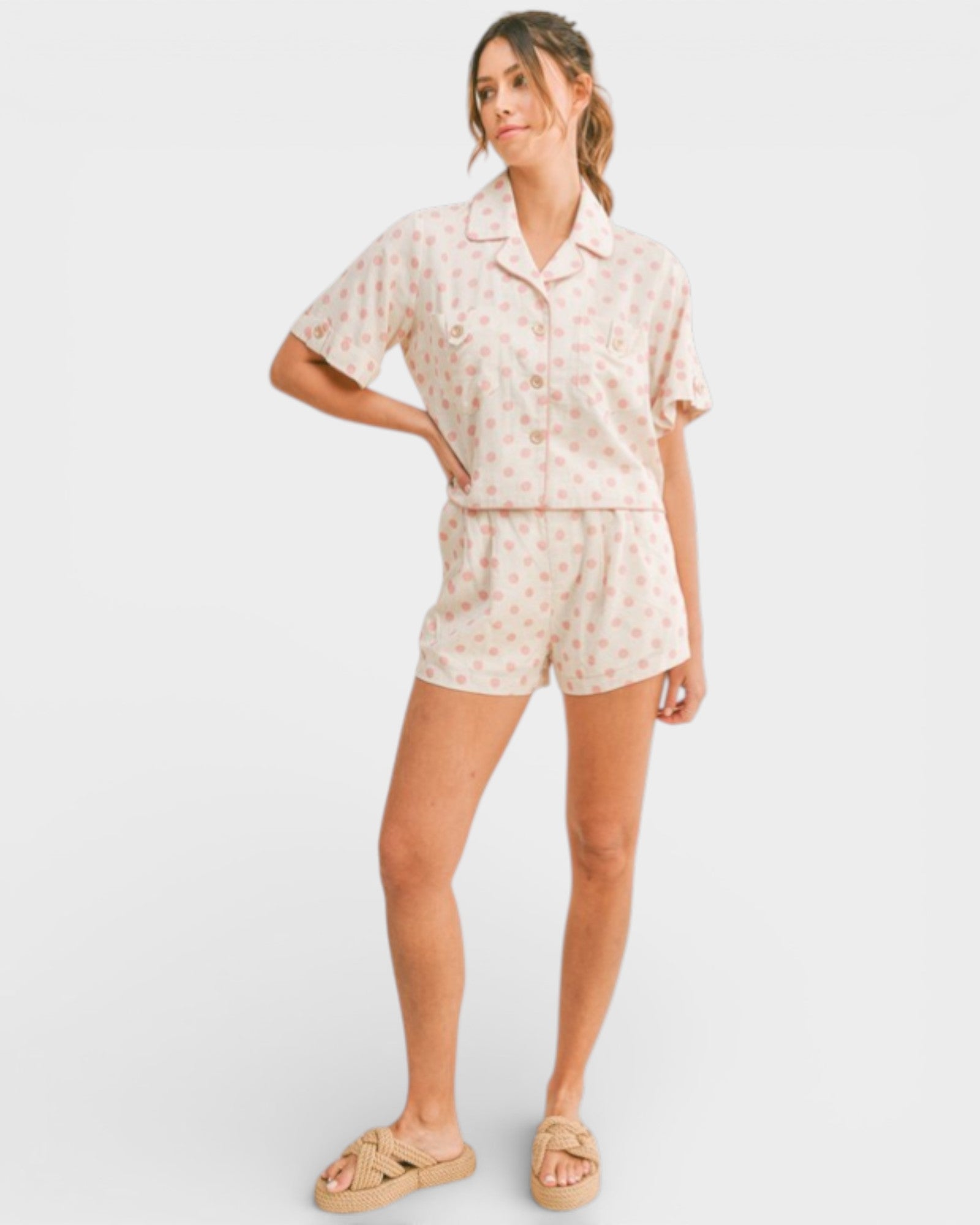 Woman wearing a floral romper on a white background