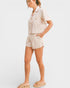 Woman wearing a floral pajama set on a white background