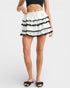White skirt with black trim worn by a person on a white background