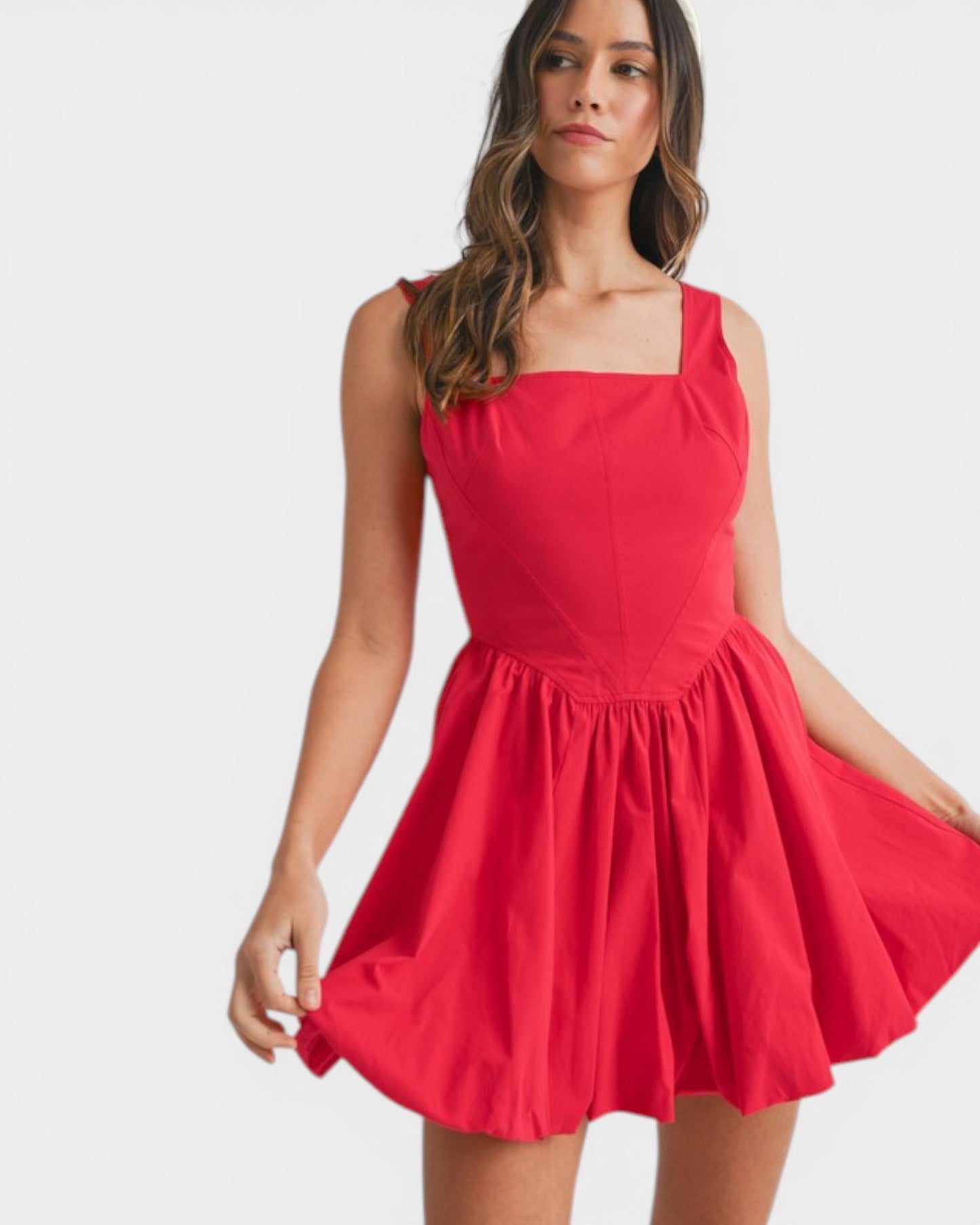 Woman wearing a red dress on a white background