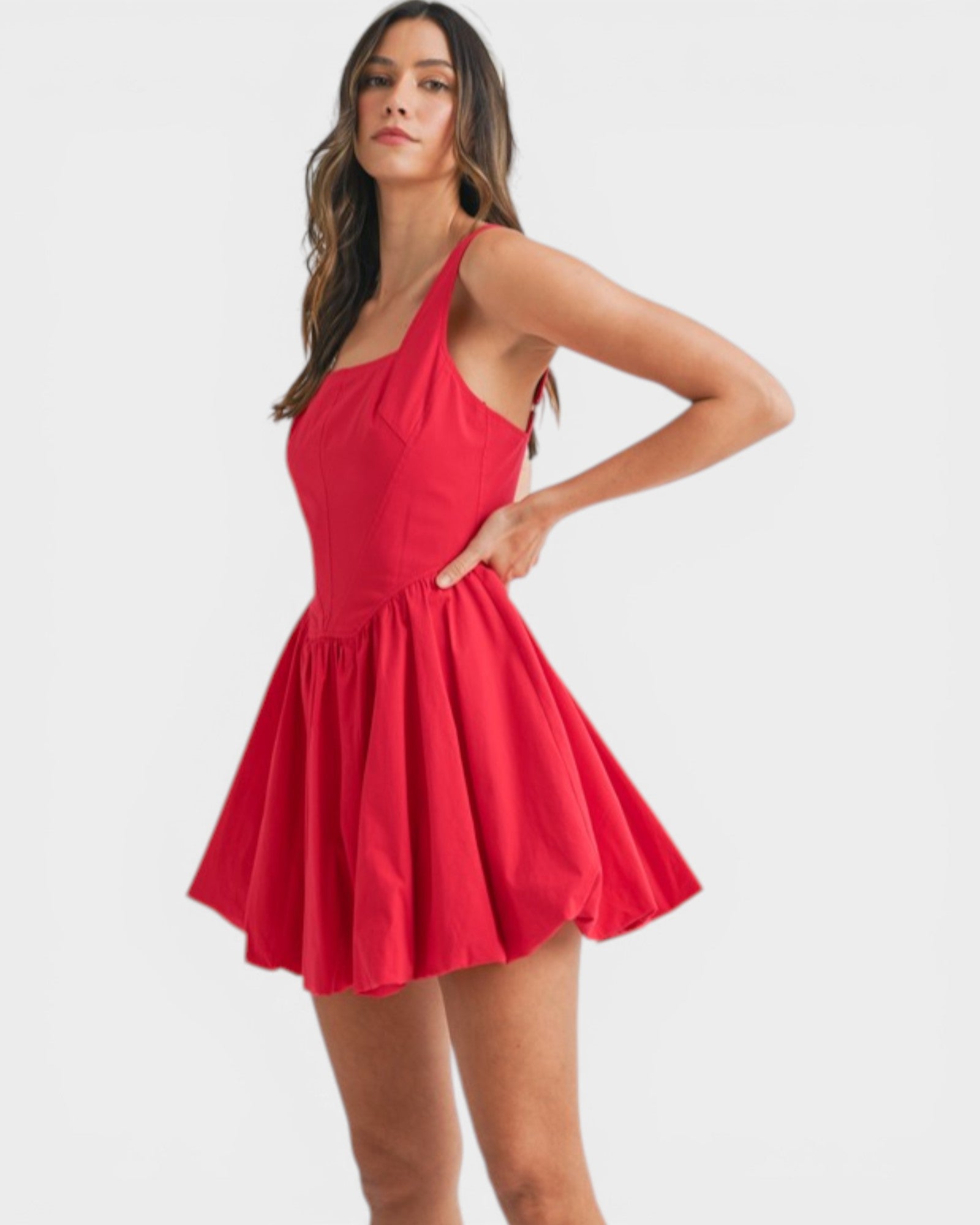 Woman wearing a red dress on a white background