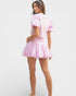 Woman wearing a pink outfit with a white background