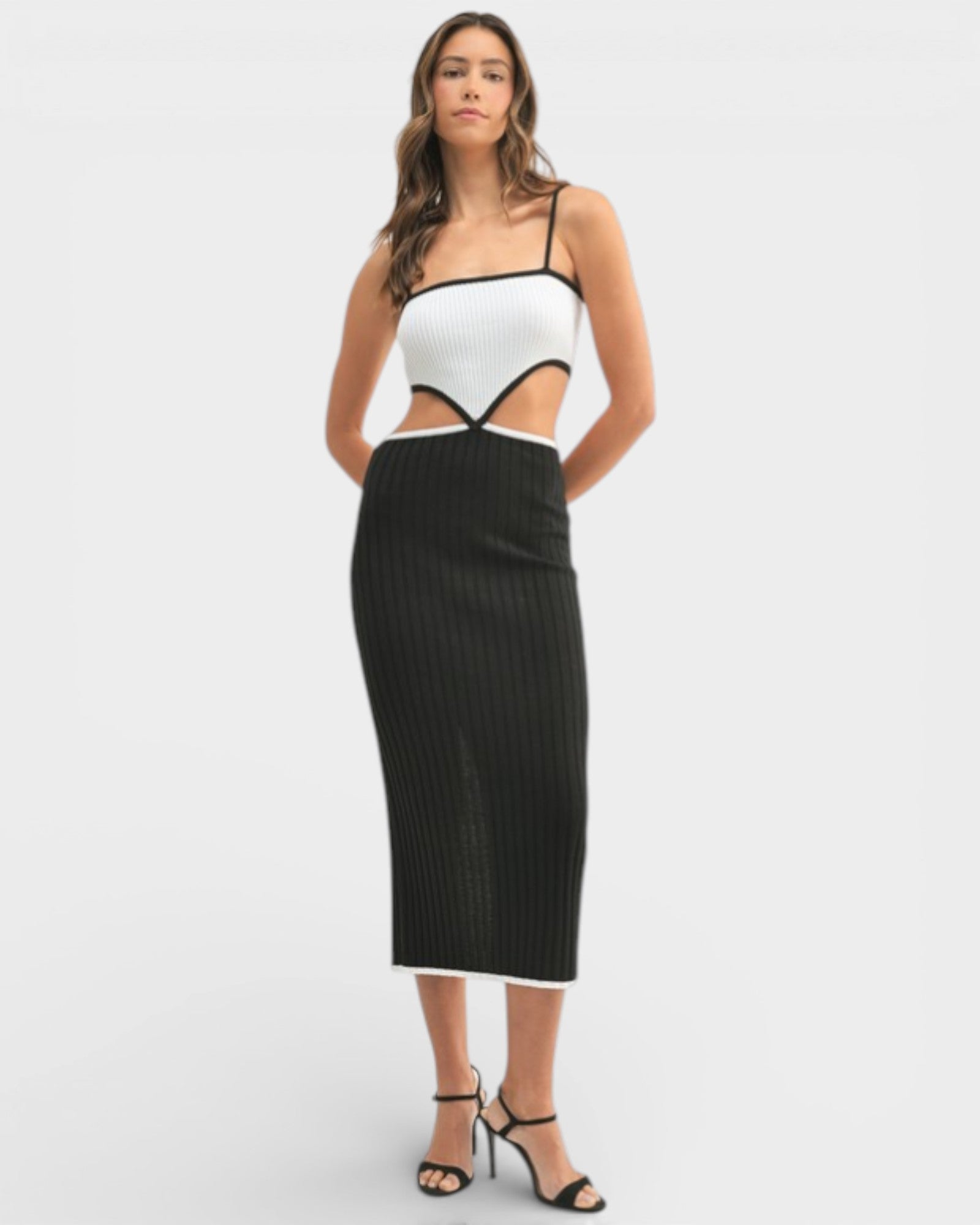 Woman wearing a white top and black skirt on a white background