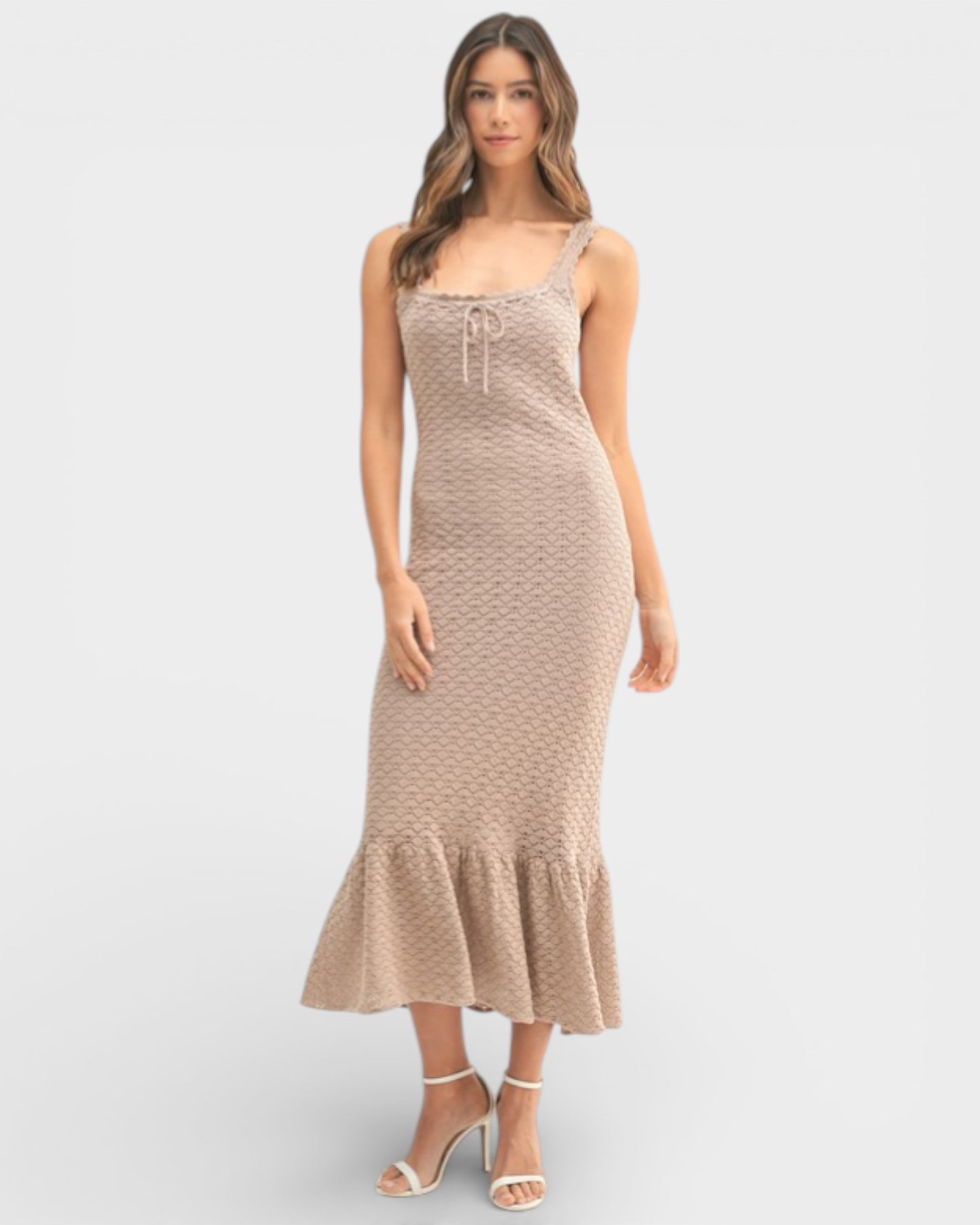 Woman wearing a beige dress with a white background