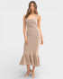 Woman wearing a beige dress with a white background