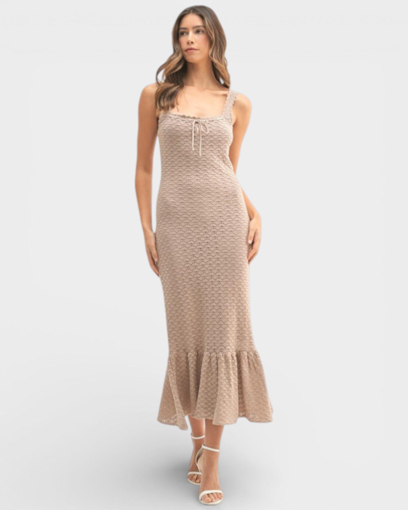 Woman wearing a beige patterned dress on a white background