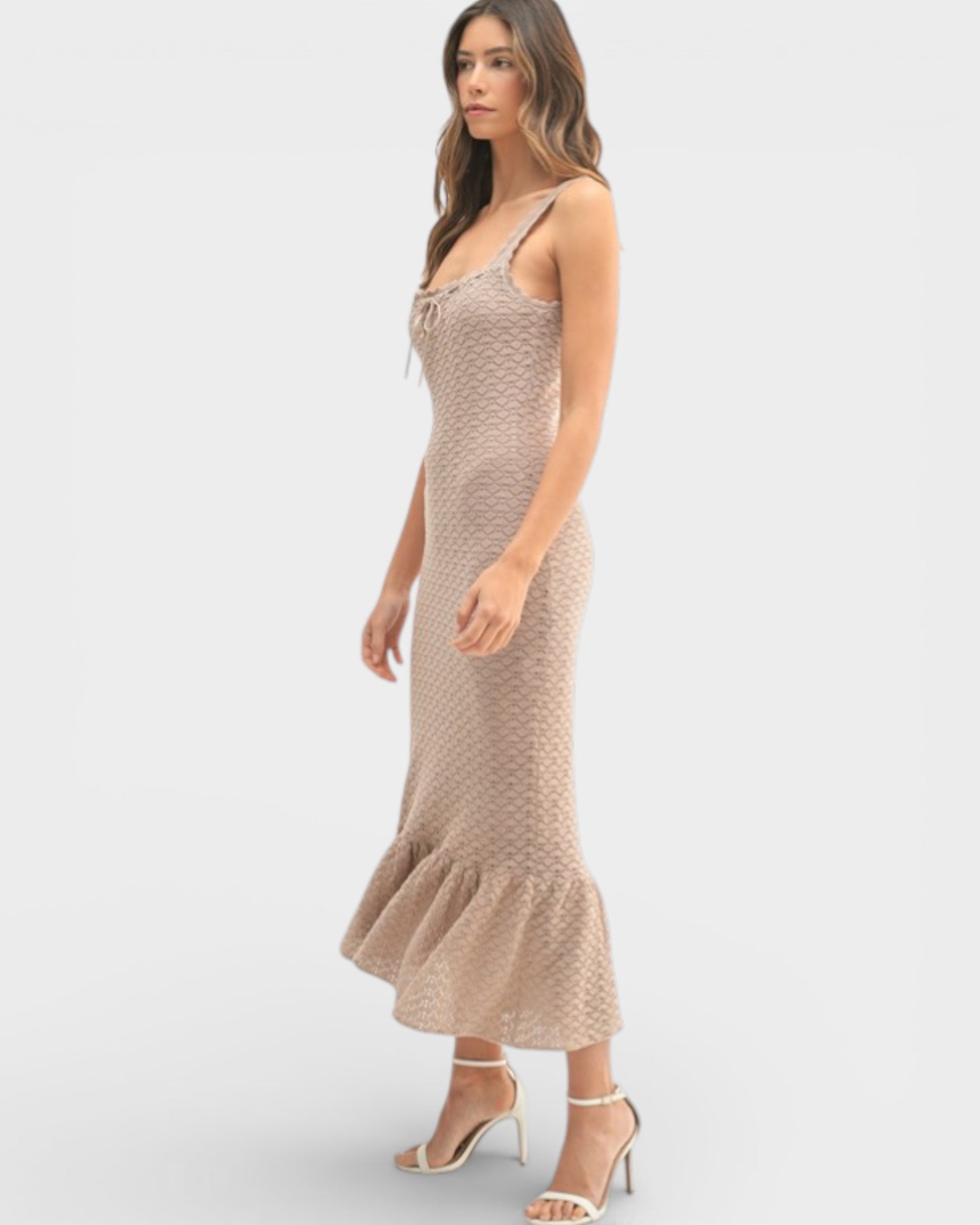 Woman wearing a beige patterned dress on a white background