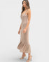 Woman wearing a beige patterned dress on a white background