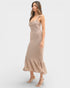 Woman wearing a beige patterned dress on a white background
