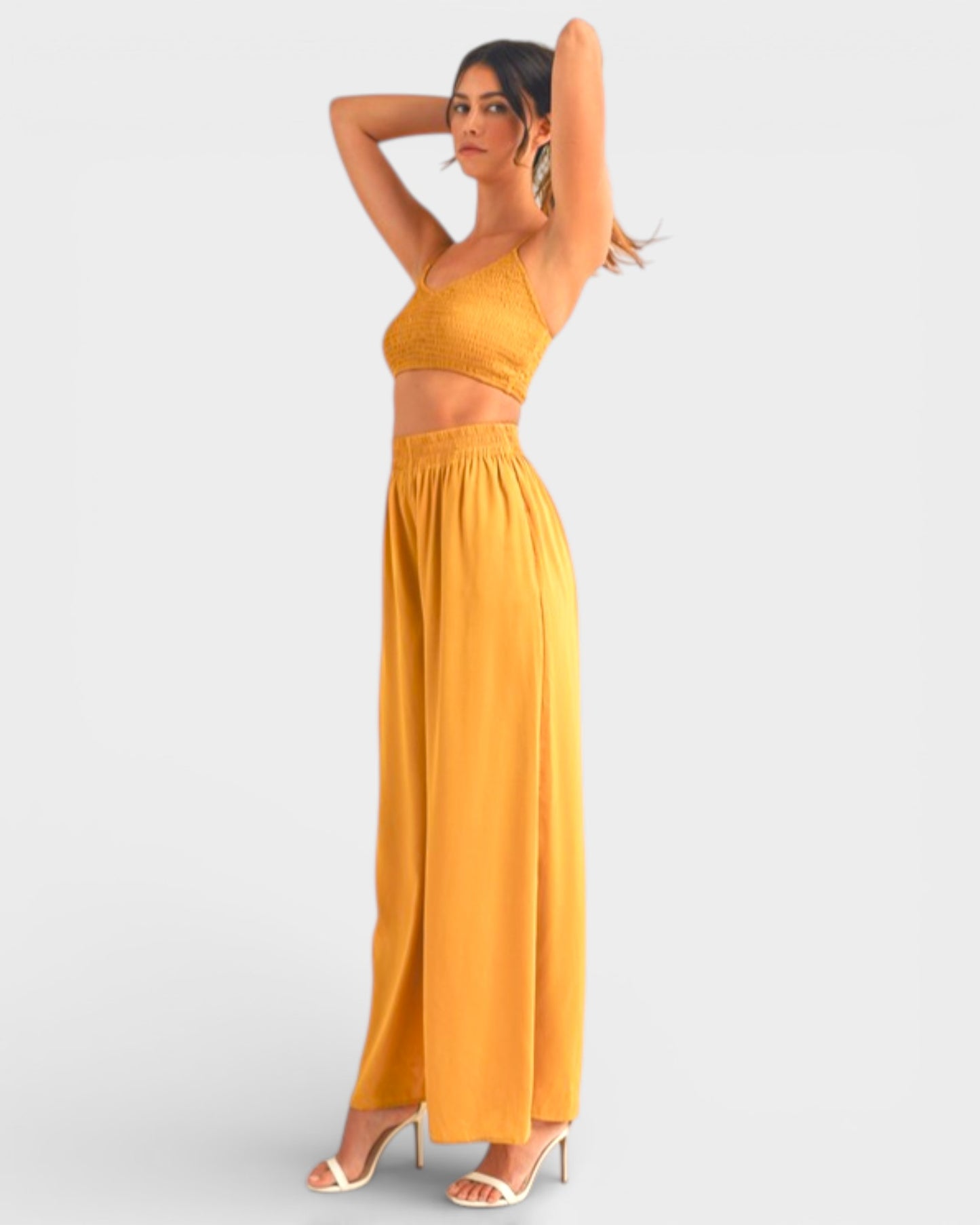 Woman wearing a yellow outfit on a white background