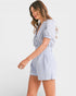 Woman wearing a blue and white striped romper on a white background