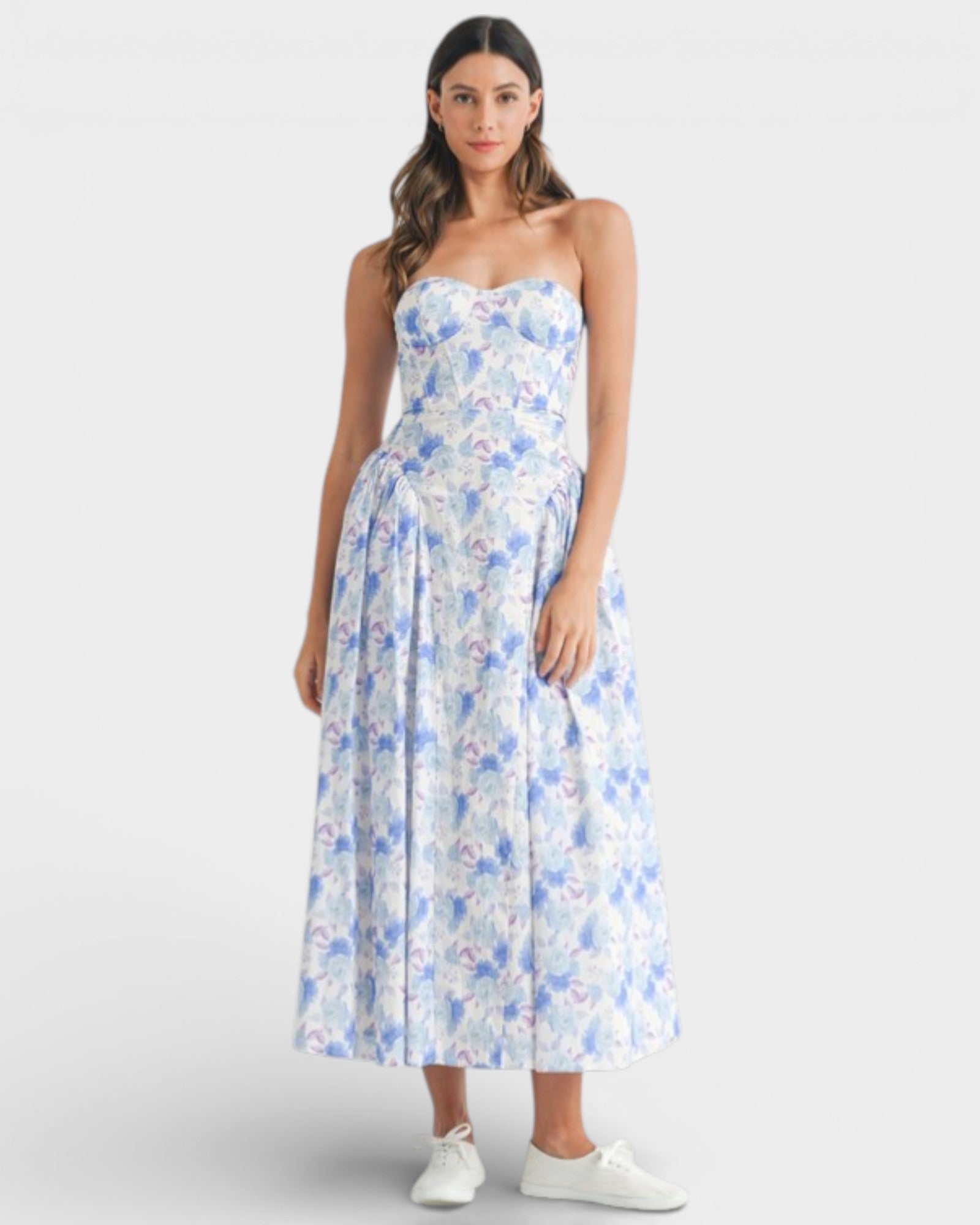 Woman wearing a strapless floral dress on a white background