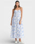 Woman wearing a strapless floral dress on a white background