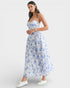 Woman wearing a strapless floral dress on a white background