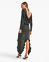 A woman modeling a black long-sleeve maxi dress with a draped open back, shown from the rear against a clean white studio background.