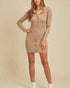 Woman wearing a beige ribbed dress against a plain background