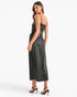 A woman modeling a black satin slip dress with spaghetti straps and a subtle embellished bodice, shown from a three-quarters back angle against a plain white studio background.