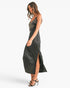 A woman modeling a black satin slip dress with silver sequin embroidery on the bodice, shown in profile against a plain white studio background.