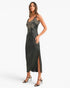 A woman modeling a black satin midi dress with silver sequin embroidery on the bodice, styled with black strappy high-heeled sandals against a light gray studio background.