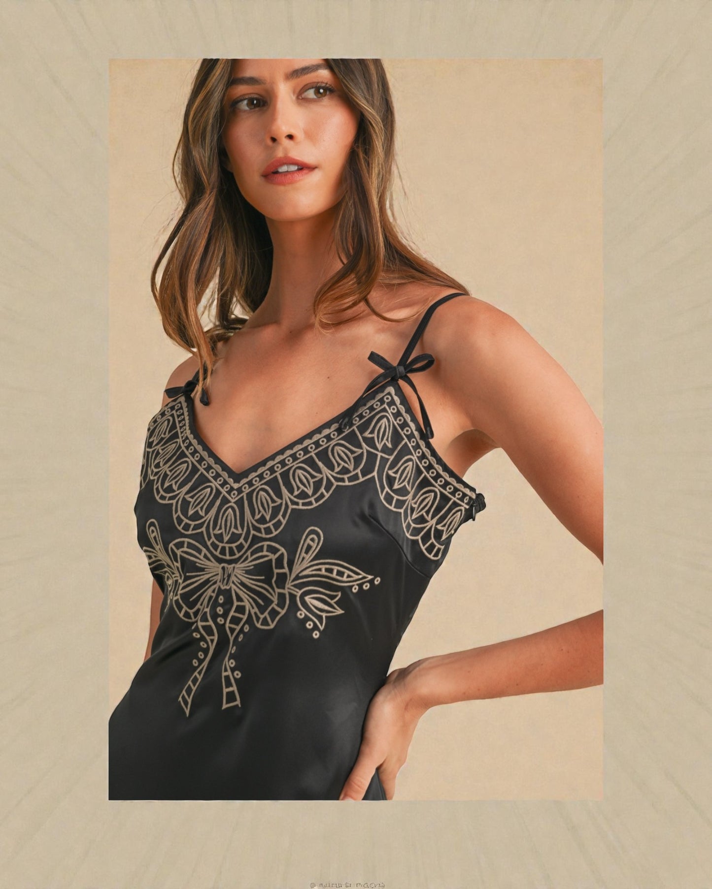 Woman wearing a black lace top against a beige background