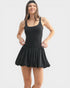 Woman wearing a black sleeveless dress with a skirt on a white background
